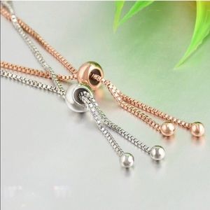 One gold colored and one silver colored bracelet